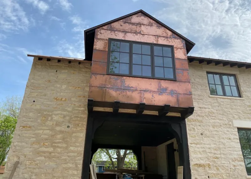 Copper metal panel facade on a stone building for Skylight Installation in Pass Christian